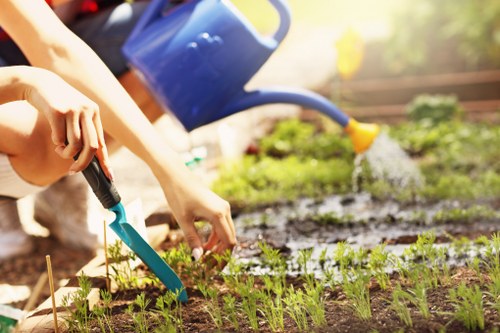 Gardener with tools and safety vest on a residential lawn