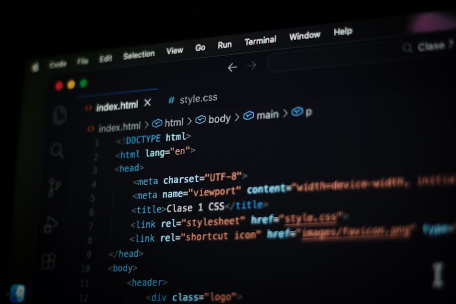 A close-up view of a computer screen displaying lines of HTML code in a dark-themed code editor. The screen shows various tags such as <html>, <head>, <title>, and link elements referencing CSS styles